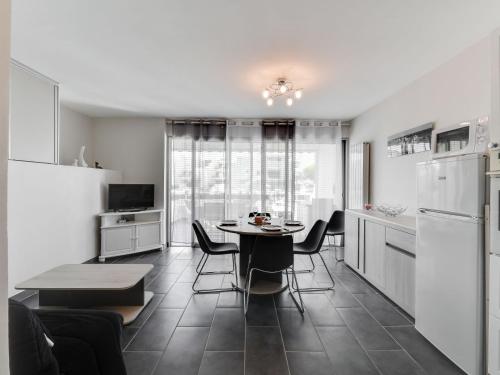 a kitchen and dining room with a table and chairs at Apartment Les Marinas de la Plage I-3 by Interhome in Le Grau-du-Roi