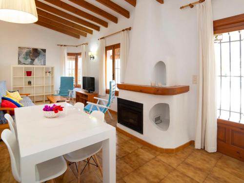 a kitchen and living room with a white table and chairs at Holiday Home Rafol by Interhome in Calpe