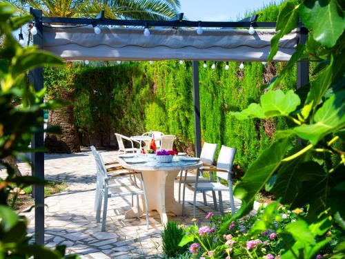 a patio with a table and chairs under a pergola at Holiday Home Rafol by Interhome in Calpe