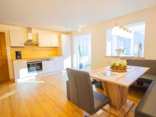 a kitchen and dining room with a table and chairs at Apartment Wennserblick by Interhome in Wenns