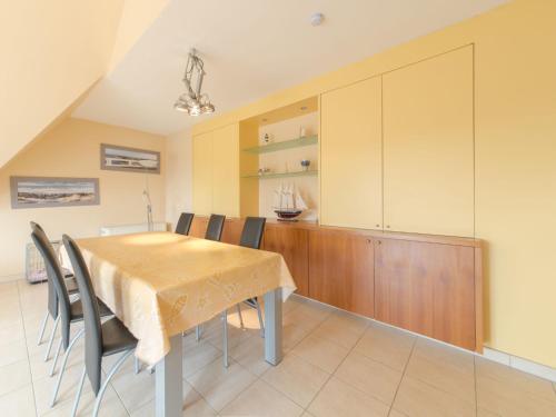 a dining room with a table and chairs at Apartment Goldsands II 402 by Interhome in De Haan