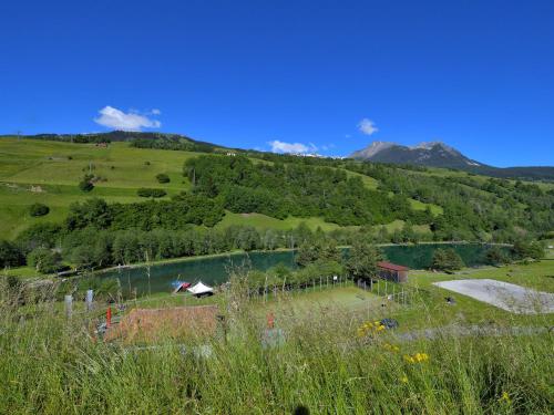 a view of a hill with a river and a house at Apartment Surses Alpin-3 by Interhome in Savognin