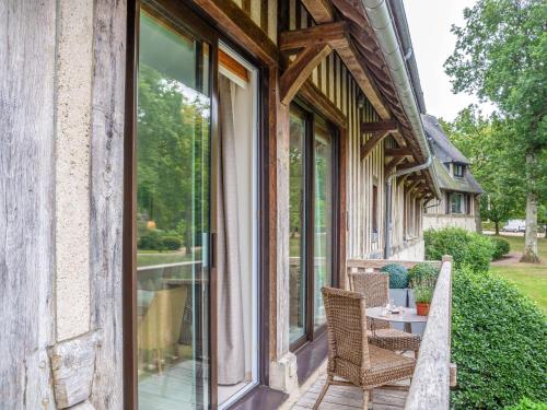 a balcony with a table and chairs on a house at Apartment Les Hauts de Deauville-2 by Interhome in Tourgeville