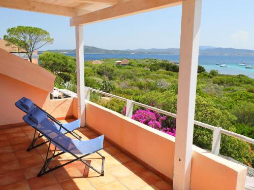 a balcony with two chairs and a view of the ocean at Apartment Vista Playa 1 by Interhome in Golfo Aranci