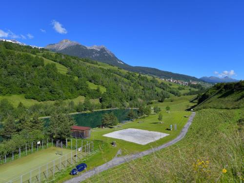 an aerial view of a park with a lake and mountains at Apartment Surses Alpin-2 by Interhome in Savognin