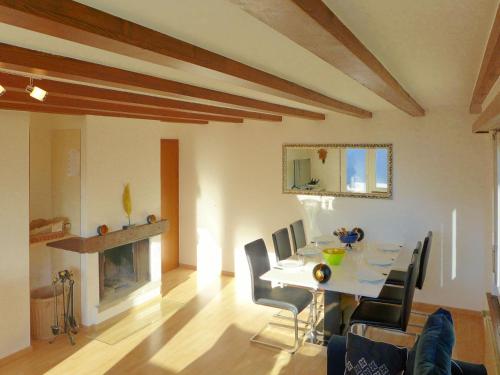 a dining room with a table and chairs and a fireplace at Chalet Maison Le Fontany by Interhome in Randogne