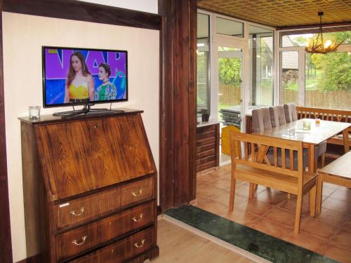 a living room with a television on top of a dresser at Holiday Home Landhaus Inselsee by Interhome in Mühl Rosin