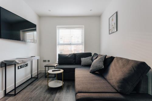 a living room with a couch and a table at Central 2 double bedroom flat with parking in Bournemouth