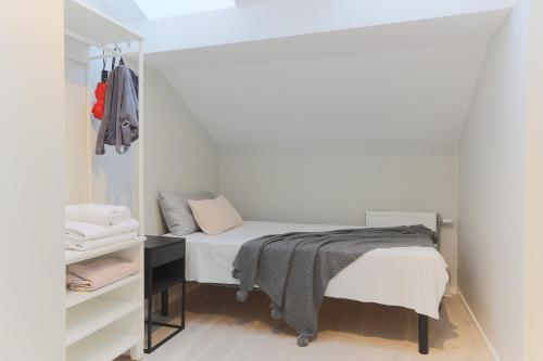 a small bedroom with a bed and a closet at Foundry Hotel Apartments in Uppsala