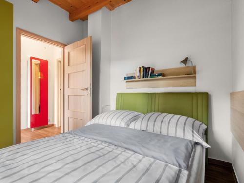 a bedroom with a bed with a green headboard at Holiday Home Bečov nad Teplou 1 by Interhome in Bečov nad Teplou