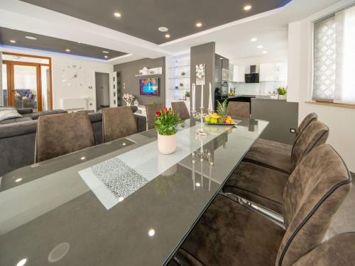 a kitchen and living room with a large table and chairs at Villa Oasis of peace by Interhome in Gornji Proložac