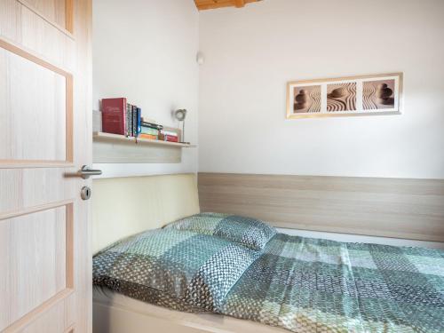 a bedroom with a bed in the corner of a room at Holiday Home Bečov nad Teplou 2 by Interhome in Bečov nad Teplou