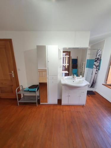 a bathroom with a sink and a mirror at Gite des luthiers in Mirecourt