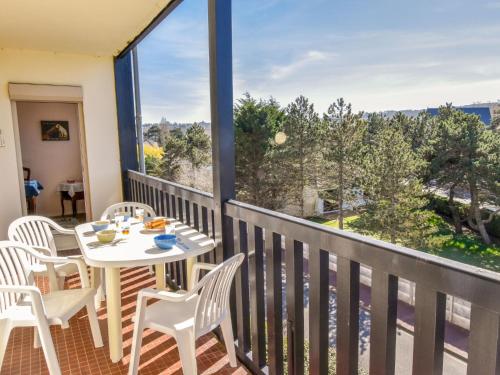 un balcon avec une table et des chaises et une grande fenêtre dans l'établissement Apartment Les Terrasses de Tourgeville-4 by Interhome, à Tourgéville