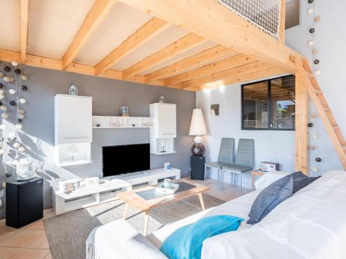 a living room with a white couch and a tv at Apartment Beaumanoir by Interhome in Quiberon