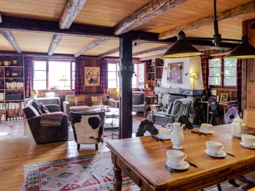 a living room filled with furniture and a table at Chalet Filaos by Interhome in Verbier
