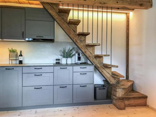 a kitchen with white cabinets and a staircase at Chalet Feldkasten by Interhome in Dorf