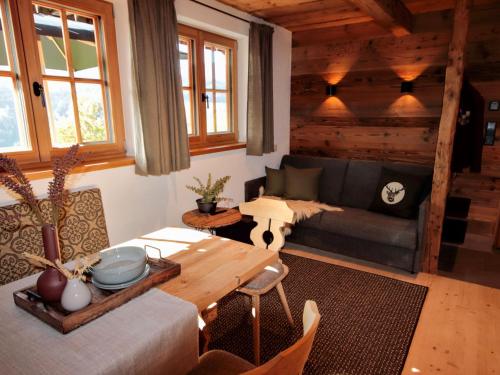 a living room with a couch and a table at Chalet Feldkasten by Interhome in Dorf