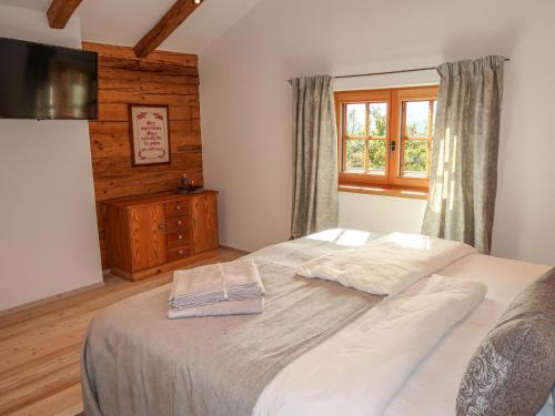 a bedroom with a large bed and a window at Chalet Feldkasten by Interhome in Dorf