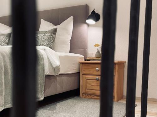 a bedroom with a bed and a wooden night stand at Chalet Feldkasten by Interhome in Dorf