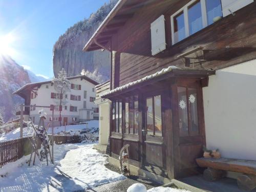a building with snow on the ground next to a building at Apartment Chalet im Gässli by Interhome in Lauterbrunnen