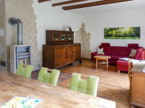 a living room with a red couch and a fireplace at Holiday Home Peenetal by Interhome in Relzow