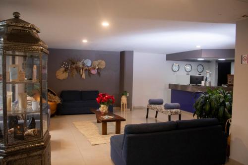 a living room with a couch and a table at Hotel HAUS Express in Orizaba