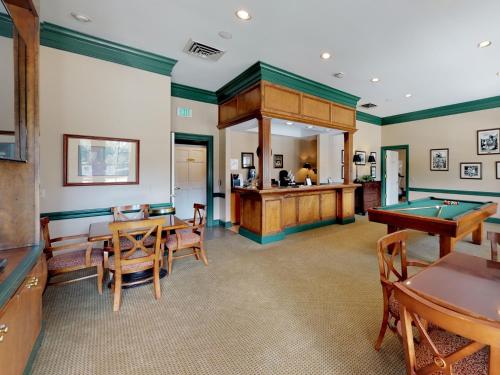 a living room with a pool table and a bar at Owners Club At Hilton Head - Managed by Elite Alliance in Hilton Head Island