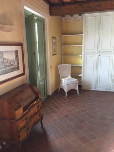 a room with a chair and a suitcase in a room at Monte A Pescia in Pescia