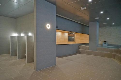a waiting room with stalls in a building at Chestertons Sokcho in Sokcho