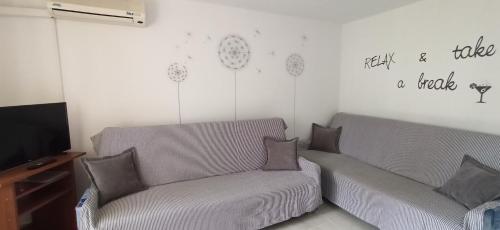 a living room with a couch and a tv at Apartments Kornati in Ždrelac