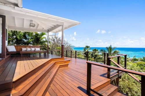 a wooden deck with a view of the ocean at A Place of Peace where heaven meets the Ocean in Kailua