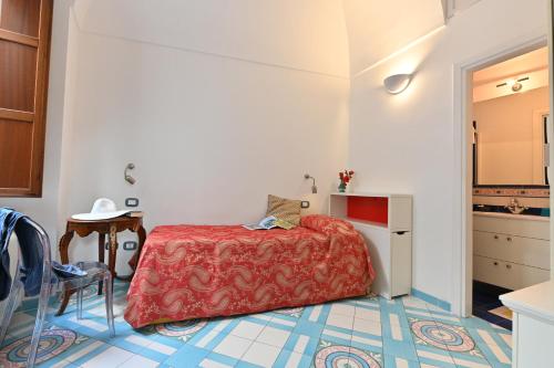a small bedroom with a bed and a table at Hotel Croce Di Amalfi in Amalfi