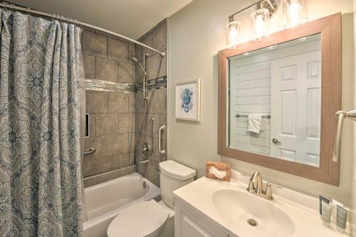a bathroom with a sink and a toilet and a tub at Walkable Hilton Head Island Condo with Resort Perks in Hilton Head Island
