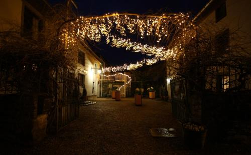 a string of lights hanging from a building at night at La Vie en Rose hotel in Gouvy