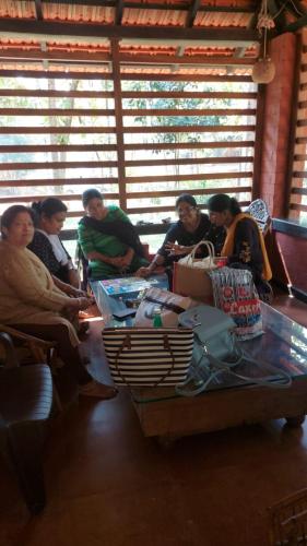 a group of people sitting around a table at NIDHIVANA FARMS & RESORT, bakrebail-salethoor rd, Mangalore in Mangalore