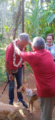 an older woman and a man standing next to a dog at NIDHIVANA FARMS & RESORT, bakrebail-salethoor rd, Mangalore in Mangalore