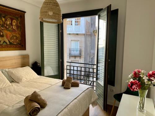 a bedroom with a bed and a large window at Afiador in Ourense
