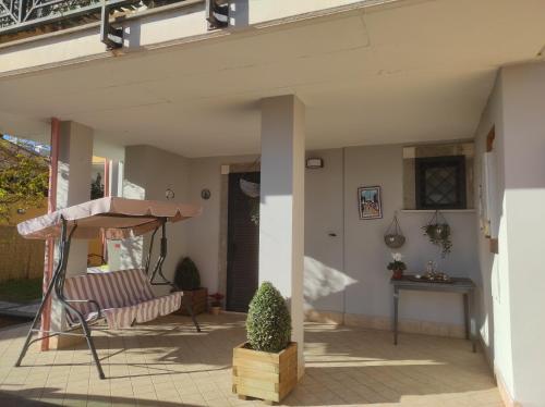 a patio with a chair and a table at Dreams House Paola-luxury suite near airport in Fiumicino