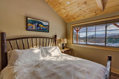 a bedroom with a bed and a window at The Lodge by Sunapee Stays in Sunapee