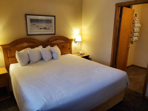 a hotel room with a bed and two lamps at Homestead Suites - Fish Creek in Fish Creek