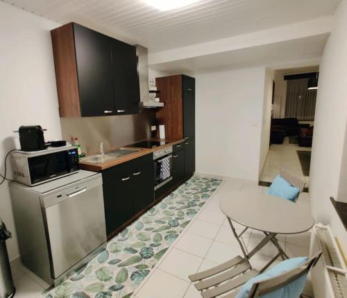 a kitchen with a stove and a white chair in it at Modern duplex 100m2 perfect to visit Brussels in Brussels