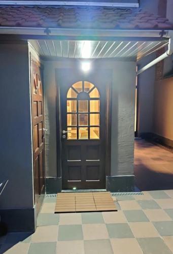 a front door of a house with a tile floor at Modern duplex 100m2 perfect to visit Brussels in Brussels