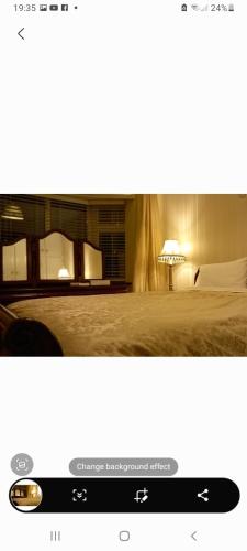 a picture of a bedroom with a bed and a lamp at Woodhaven Manor h91rc9d in Galway