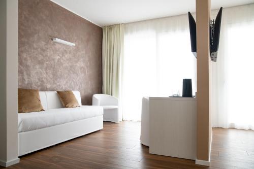a living room with a white couch in front of a window at Arca Guest House in San Trovaso