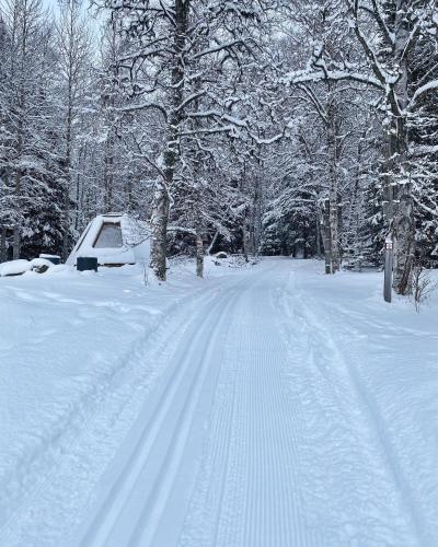 a snow covered road with a car parked on it at Hotell Åre Fjällsätra in Undersåker