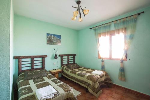 Un pat sau paturi într-o cameră la El Robledillo