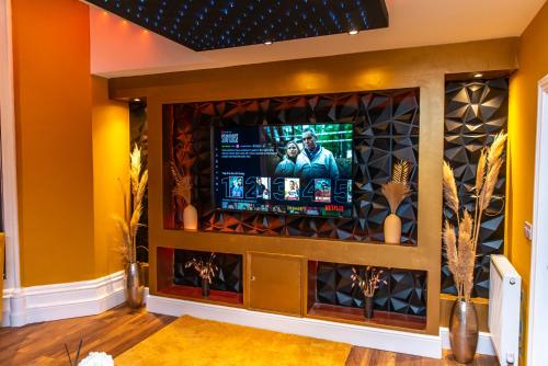 a living room with a tv in a wall at Optimal Apartments in Bradford