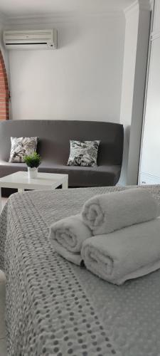 a bedroom with a bed with towels on it at Estudio TORROX PLAYA- vistas al mar y piscina in Torrox Costa