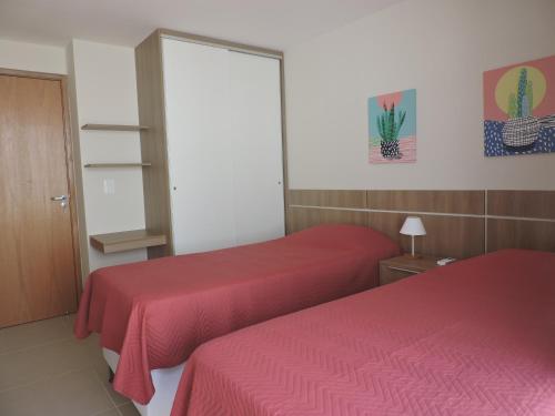 Ένα ή περισσότερα κρεβάτια σε δωμάτιο στο Itacimirim - Village na Praia da Espera